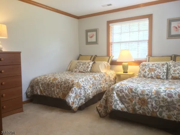 a bedroom with two beds and a window