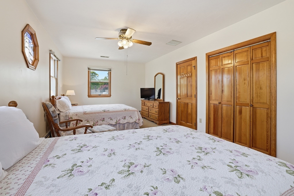 7 Swift Avenue Wareham, MA 02571 - Photo 31 of 42 a bedroom with a large bed and a chandelier