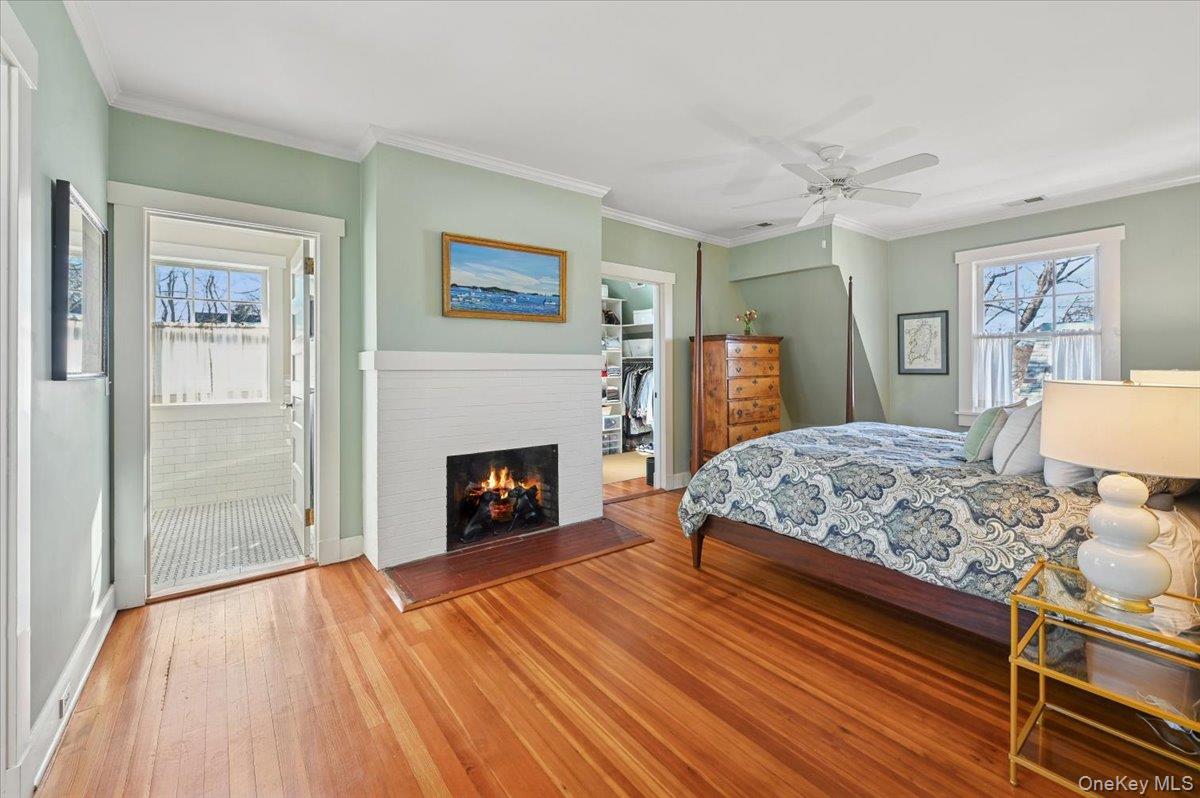 31 Emerson Road Larchmont, NY 10538 - Photo 18 of 43 The primary suite has a walk in closet through the door in the back right. The fireplace works beautifully...not hot enough for the air conditioning? Flip on the ceiling fan..The primary bath is through the door to the left and an office is not shown but to the hard left.