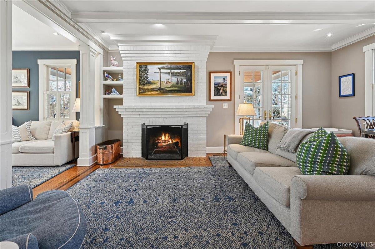 31 Emerson Road Larchmont, NY 10538 - Photo 3 of 43 This is the view into the living room from the front hall. The doors to the right lead to the porch. To the left is a sun room that gets wonderful afternoon light. The fireplace is wood burning.