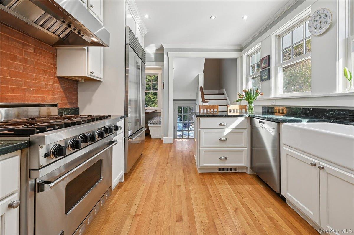 31 Emerson Road Larchmont, NY 10538 - Photo 9 of 43 High end updated kitchen with a brick accent wall behind the Viking stove.