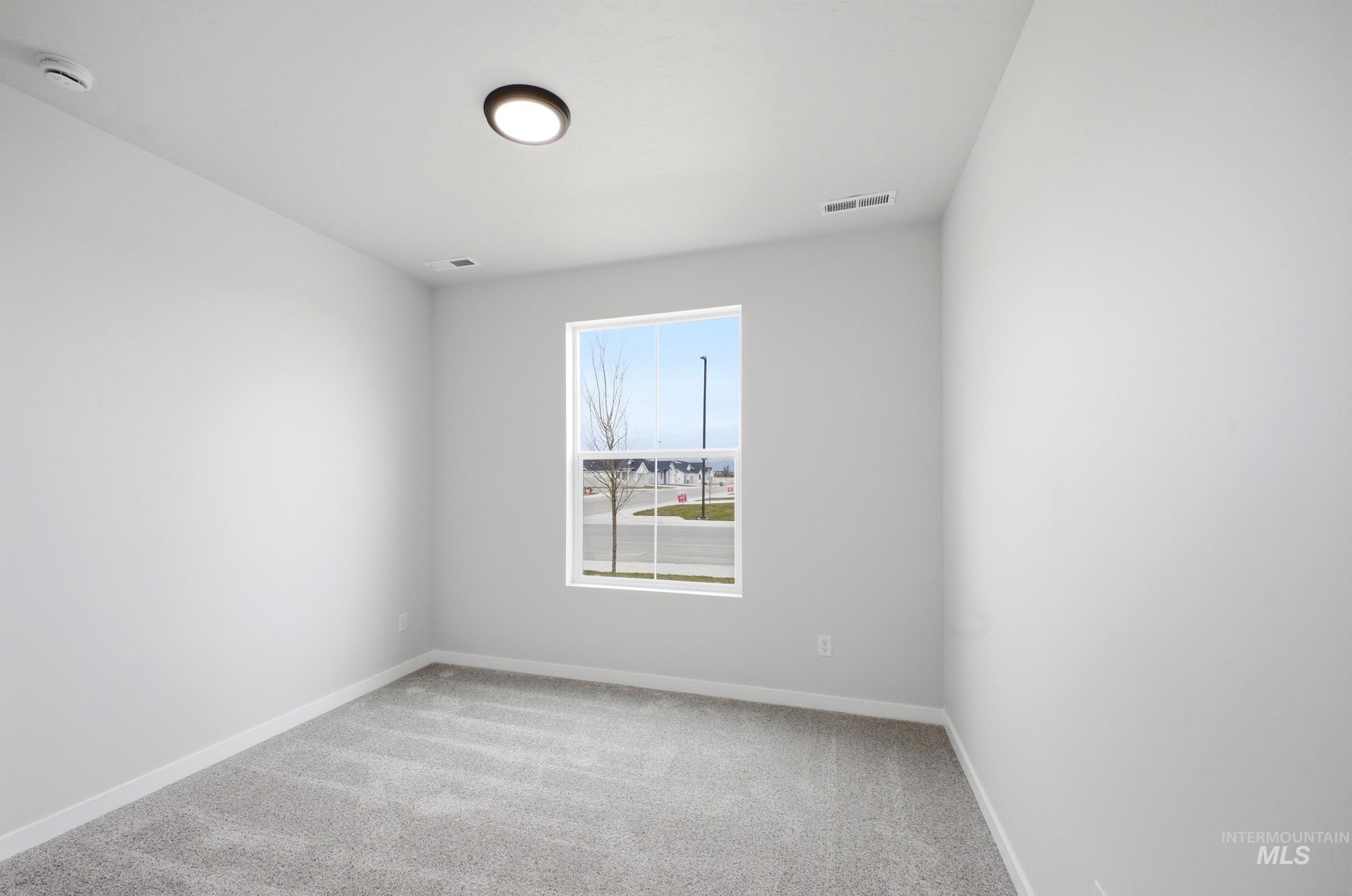 14104 Shiny Spruce Street Caldwell, ID 83607 - Photo 10 of 20 Room featuring a single window, light gray carpeting, and white baseboards