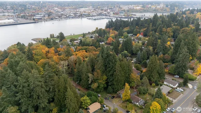 an aerial view of lake and residential houses with outdoor space