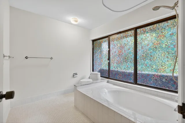 a bathroom with a bathtub and a shower
