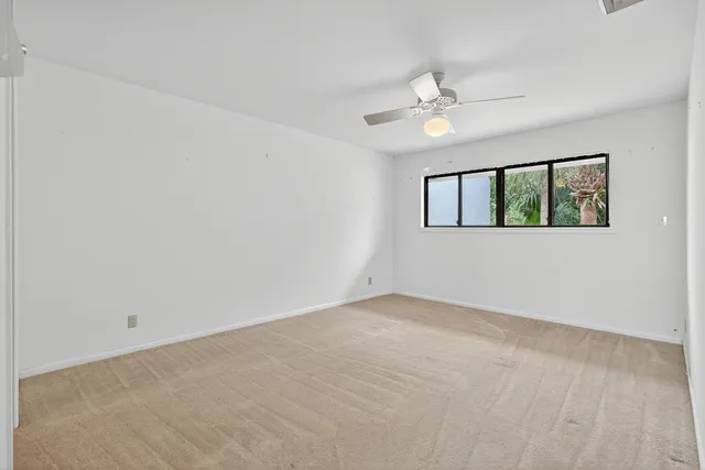 a view of a house with pool and chairs