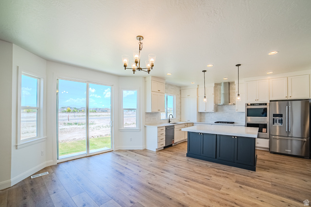 45 North Scarlet Maple Road, Unit 4317 Vineyard, UT 84059 - Photo 12 of 35 Open-concept kitchen and dining area featuring wide plank wood-finish flooring