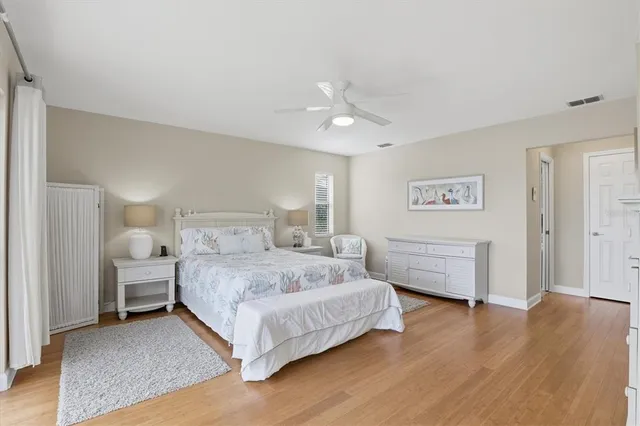 a bedroom with a bed and a painting on the wall