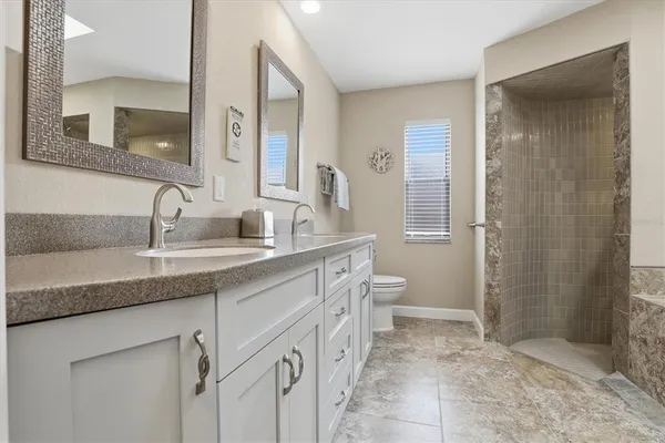 a bathroom with a shower a mirror and a sink