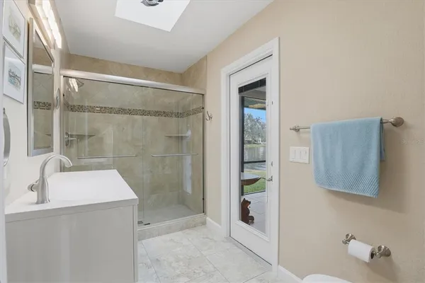 a view of a patio with couches table and chairs with potted plants and big yard