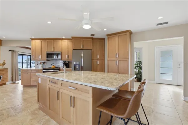 a living room with furniture a fireplace and a large window