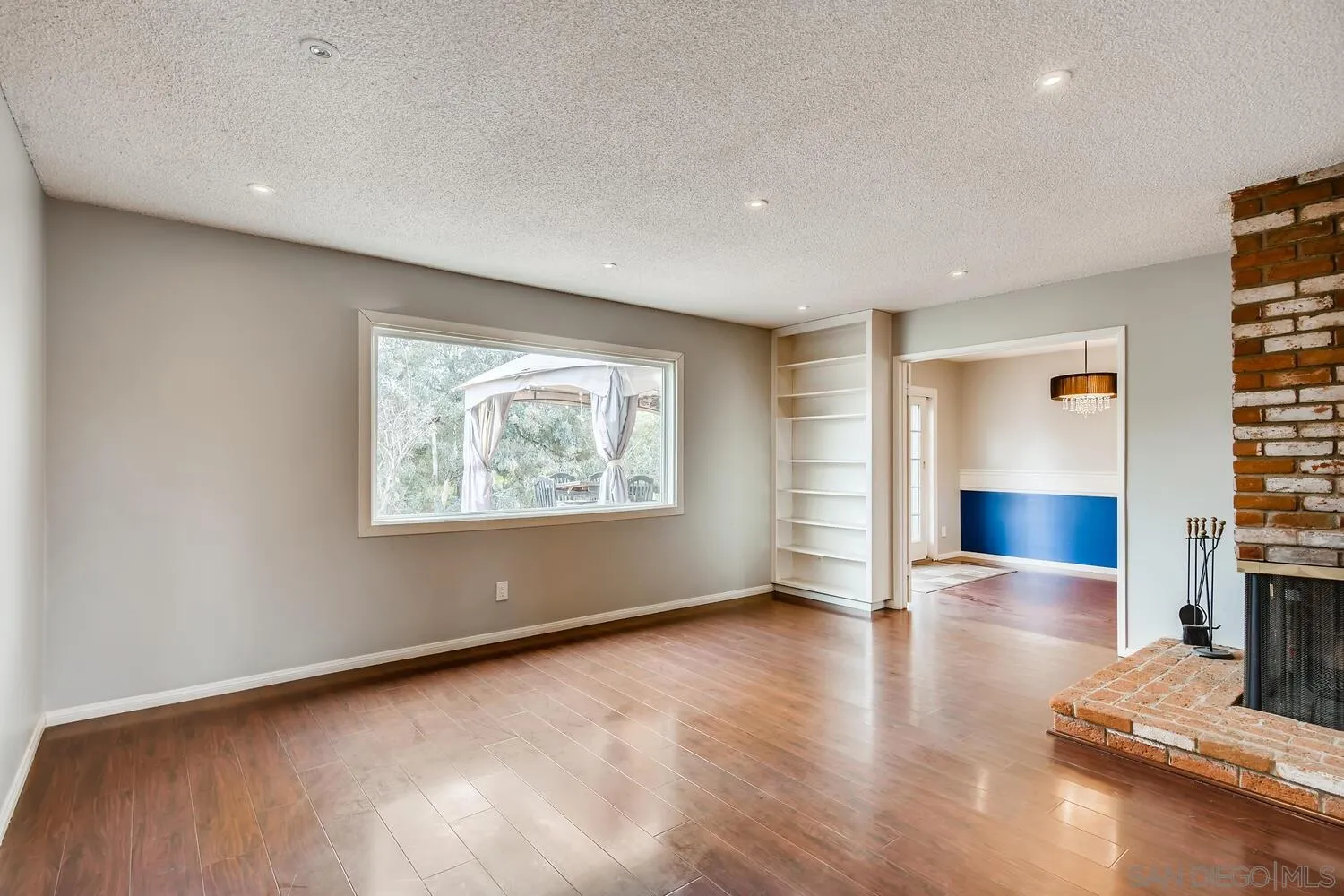 9340 Oakbourne Road Santee, CA 92071 - Photo 7 of 26 an empty room with wooden floor and windows