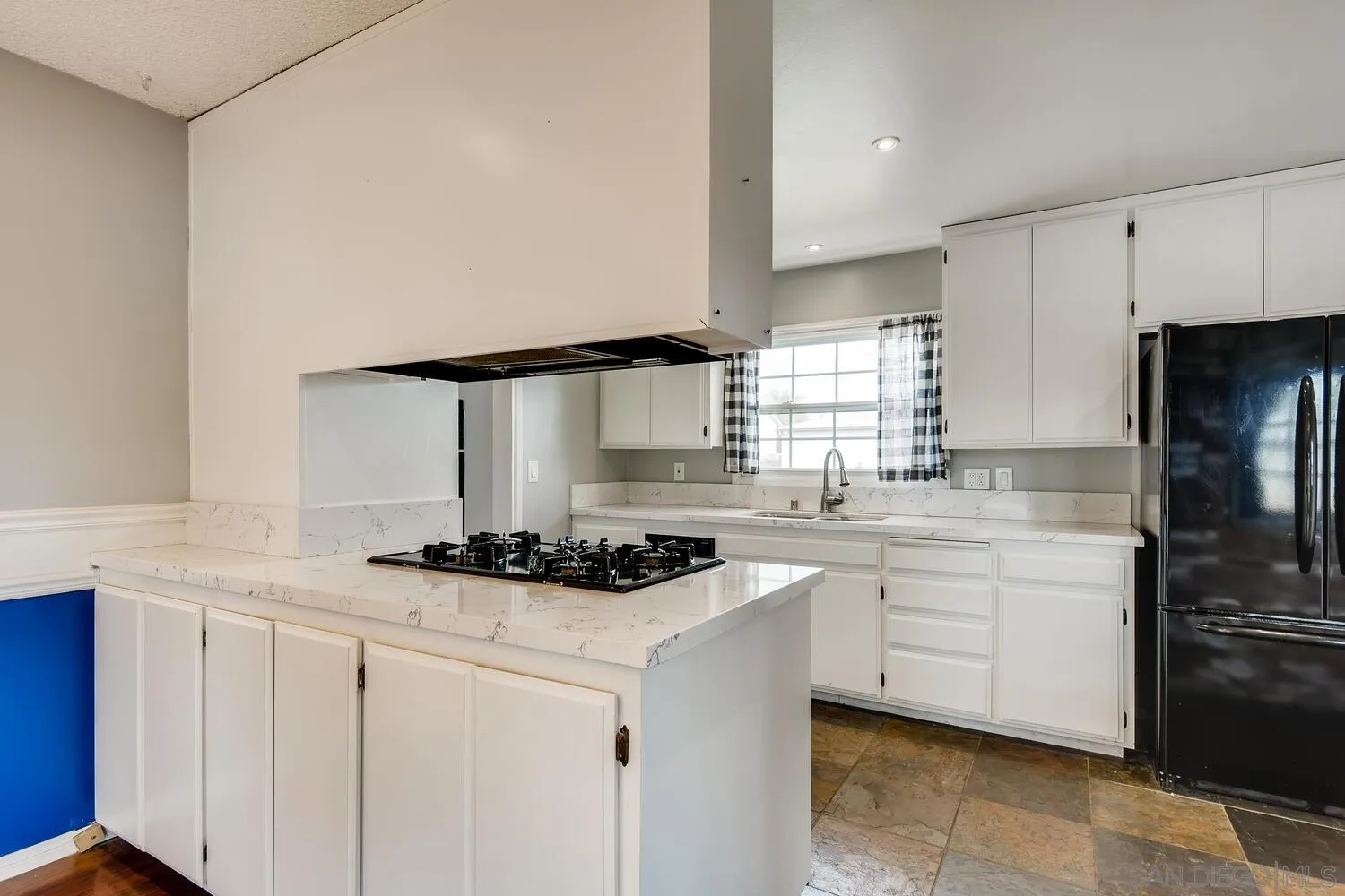 9340 Oakbourne Road Santee, CA 92071 - Photo 10 of 26 a kitchen with stainless steel appliances granite countertop a sink stove and refrigerator