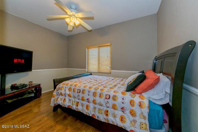3701 East Northern Dancer Road Tucson, AZ 85739 - Photo 15 of 32 a bedroom with a bed and a flat screen tv