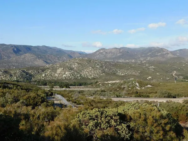 a view of mountain with green field
