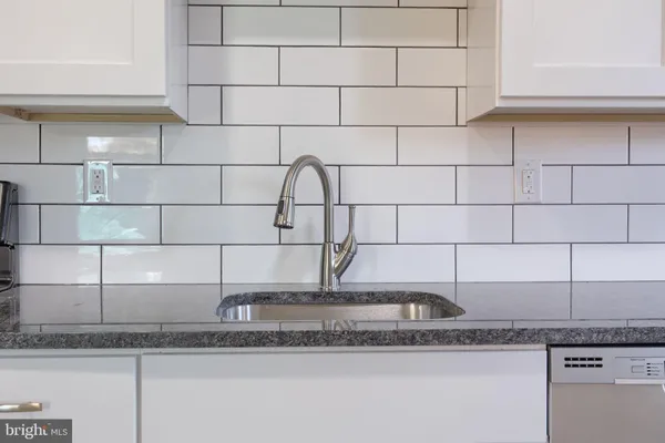 a kitchen with stainless steel appliances granite countertop a sink and a stove