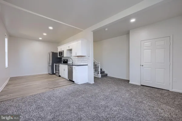 a kitchen with granite countertop a stove and a sink