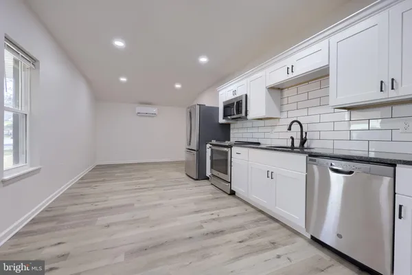 a kitchen with stainless steel appliances granite countertop a sink and cabinets