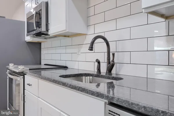 a kitchen with a sink and cabinets
