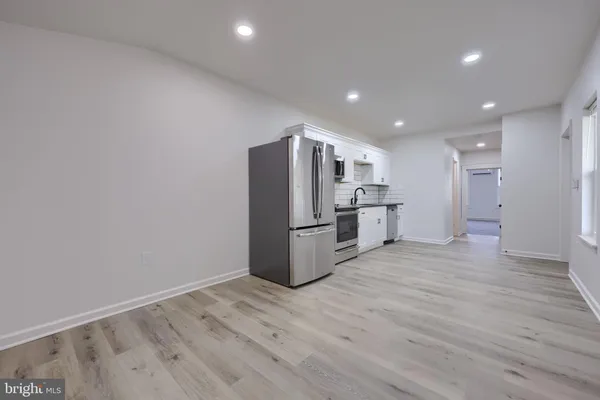 a kitchen with stainless steel appliances a refrigerator and a sink