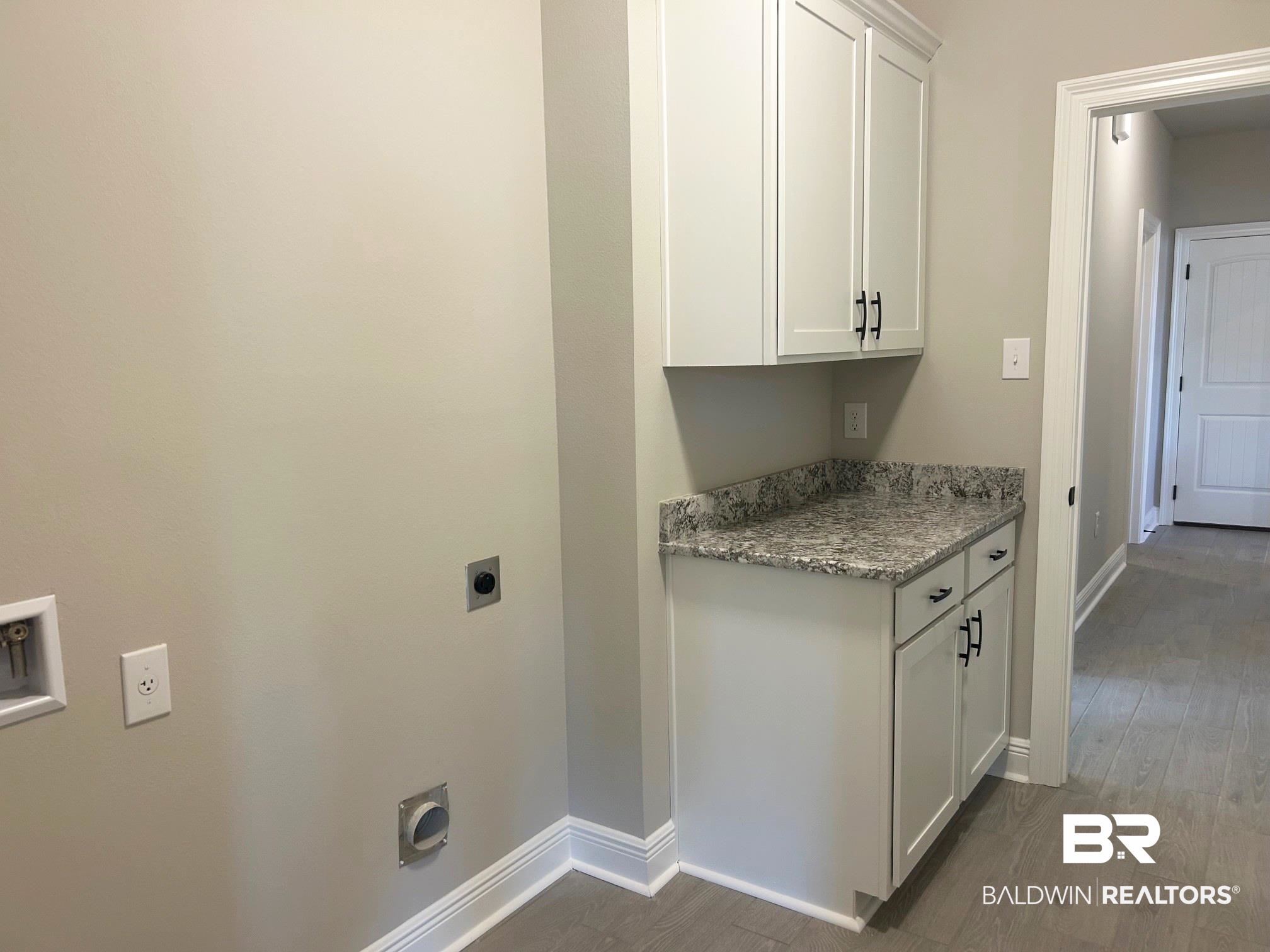 881 Sumter Loop Foley, AL 36535 - Photo 16 of 19 Laundry area featuring cabinets, dark hardwood / wood-style floors, and electric dryer hookup