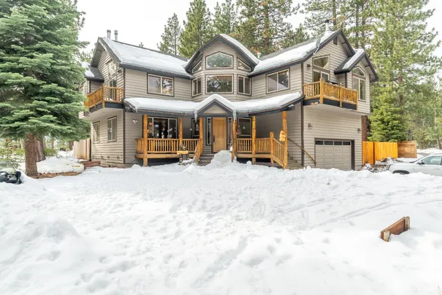 a front view of a house with a snow in the yard