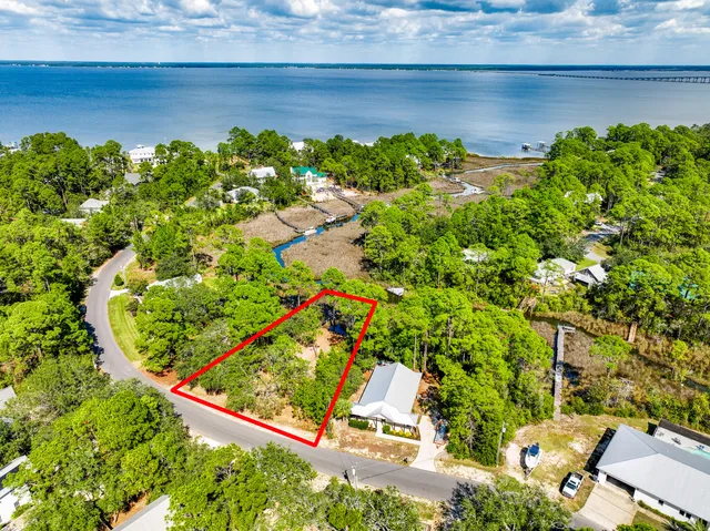 an aerial view of a houses with a yard