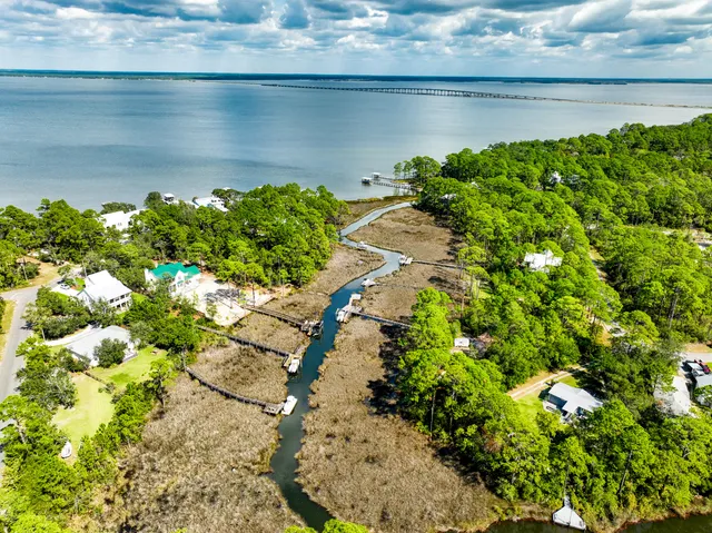 a backyard of a house with a yard outdoor seating and covered with trees