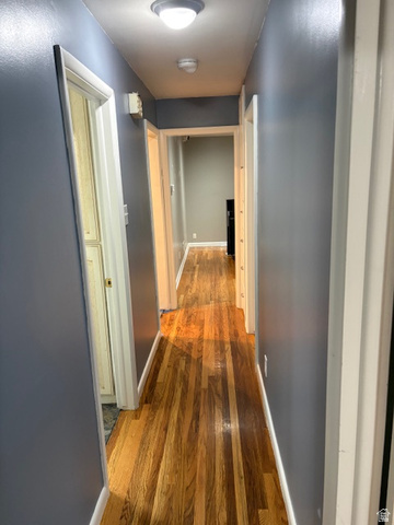 2313 150 East Bountiful, UT 84010 - Photo 13 of 39 Hallway featuring wood-finish flooring, light gray walls, and white trim