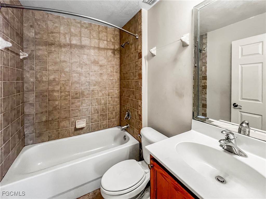 13437 First Street Fort Myers, FL 33905 - Photo 14 of 22 a bathroom with a sink a toilet and a bathtub