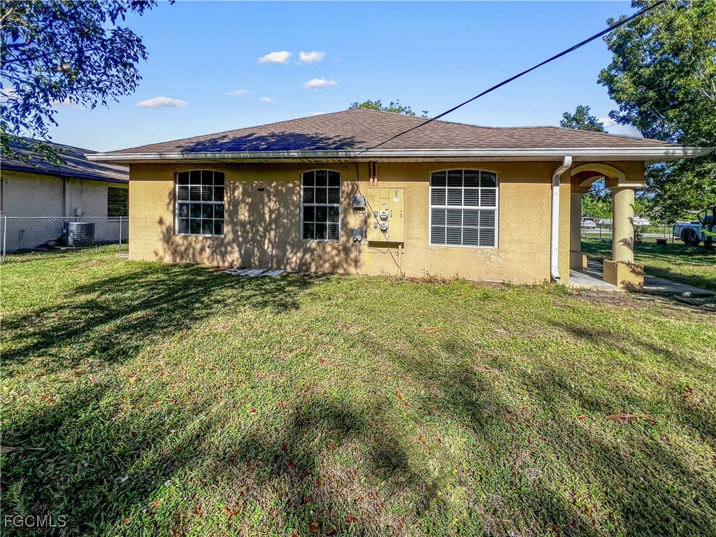 13437 First Street Fort Myers, FL 33905 - Photo 20 of 22 a front view of a house with a yard