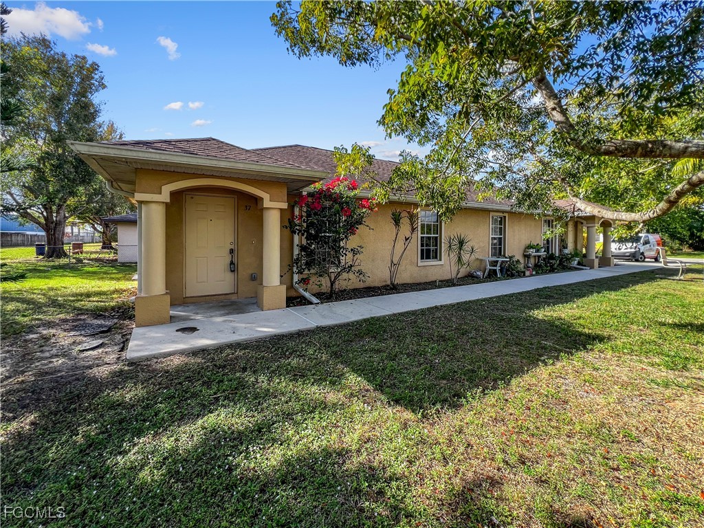13437 First Street Fort Myers, FL 33905 - Photo 2 of 22 a view of a house with garden and yard