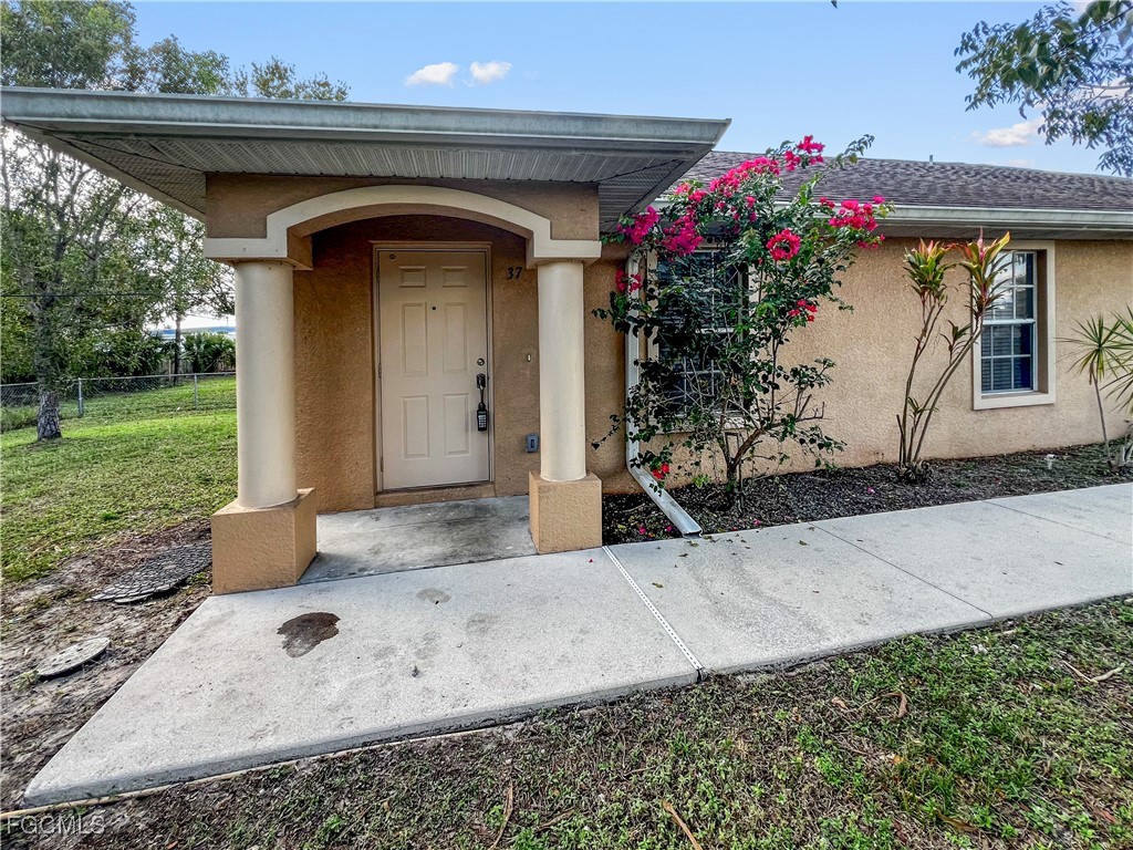 13437 First Street Fort Myers, FL 33905 - Photo 3 of 22 a front view of a house with a porch
