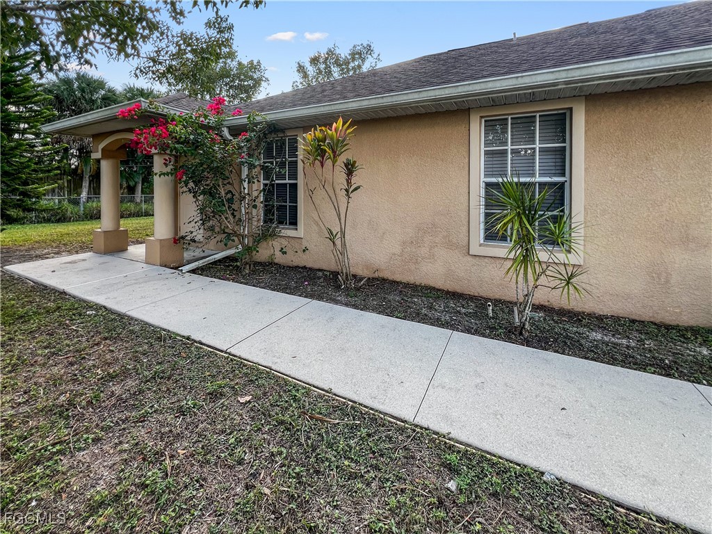 13437 First Street Fort Myers, FL 33905 - Photo 4 of 22 a front view of a house with garden