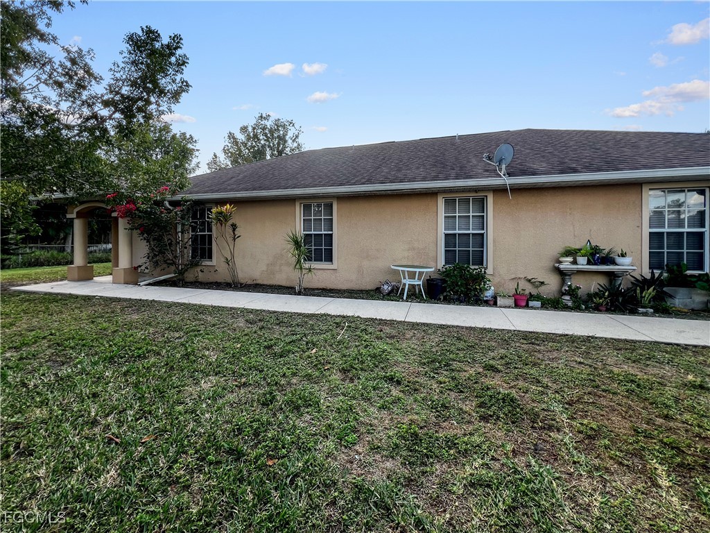 13437 First Street Fort Myers, FL 33905 - Photo 5 of 22 a front view of a house with a yard