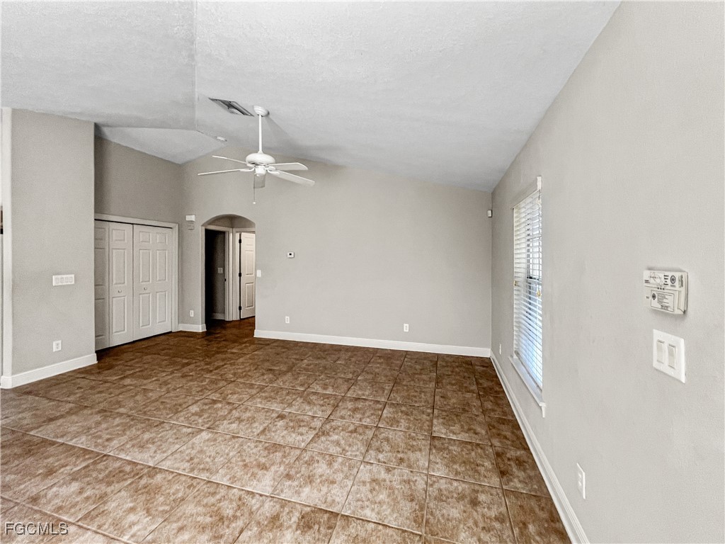13437 First Street Fort Myers, FL 33905 - Photo 7 of 22 a view of a hallway with a chandelier fan and windows