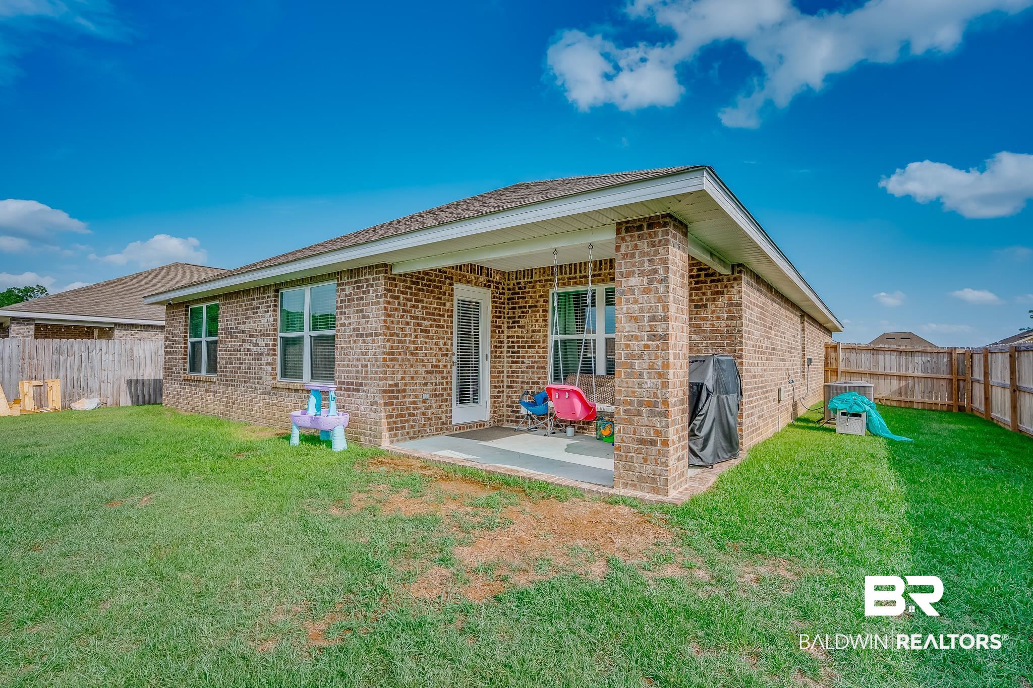 8242 Sycamore Way Semmes, AL 36575 - Photo 32 of 43 Rear view of house featuring brick siding, a fenced backyard, and a patio