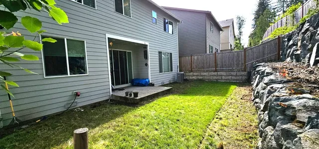 a view of a house with backyard and sitting area