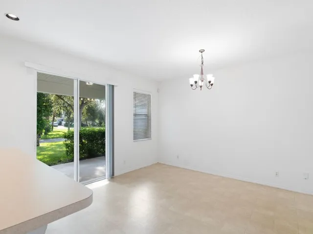 an empty room with windows and outdoor view