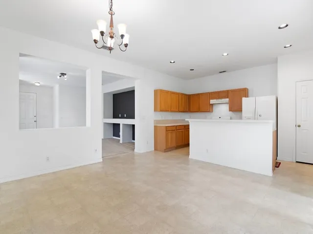 a view of a kitchen with a sink and a chandelier