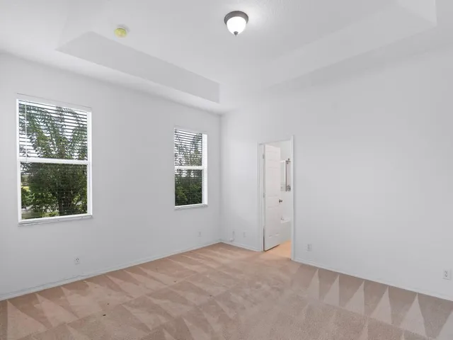 an empty room with windows and closet