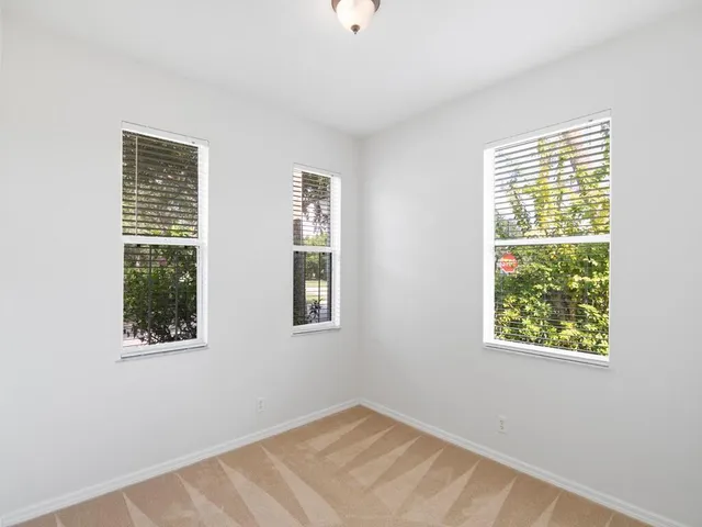 a view of an empty room with windows