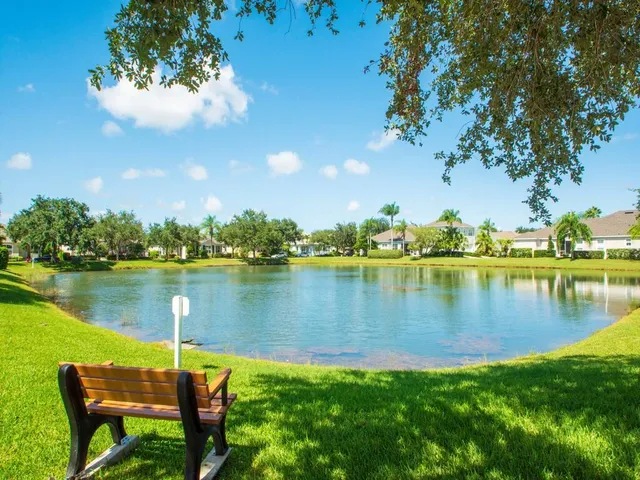 a view of a lake with a table and chairs