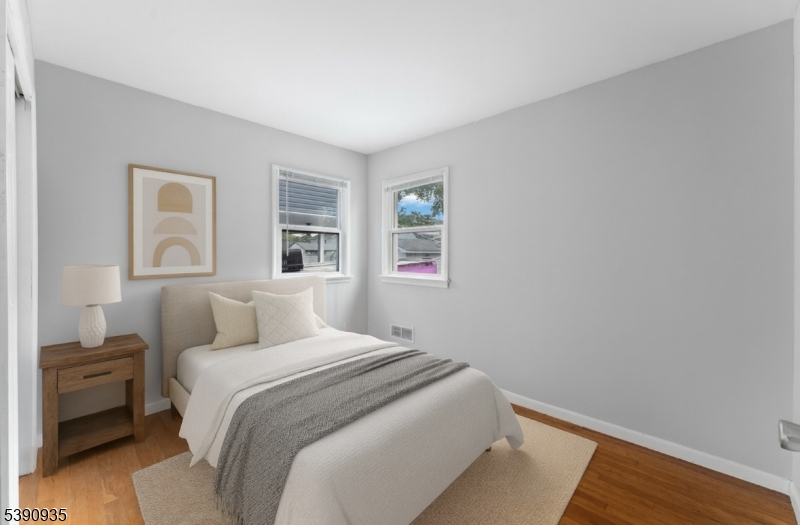 87 Pompton Avenue Little Falls, NJ 07424 - Photo 17 of 34 a bedroom with a bed and a night stand