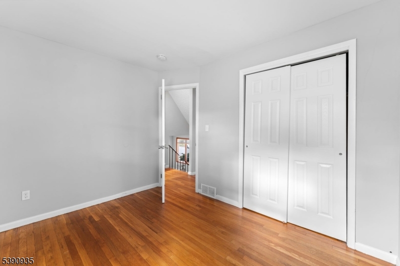 87 Pompton Avenue Little Falls, NJ 07424 - Photo 18 of 34 a view of empty room with wooden floor
