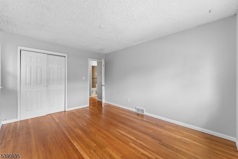 87 Pompton Avenue Little Falls, NJ 07424 - Photo 20 of 34 a view of an empty room with wooden floor