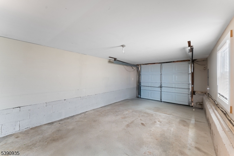 87 Pompton Avenue Little Falls, NJ 07424 - Photo 34 of 34 an empty room with a fireplace and painted walls
