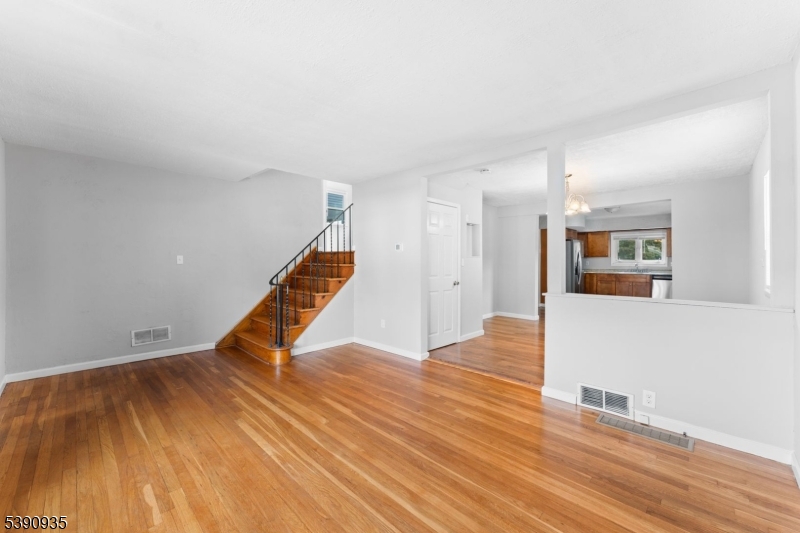 87 Pompton Avenue Little Falls, NJ 07424 - Photo 7 of 34 a view of an empty room with wooden floor