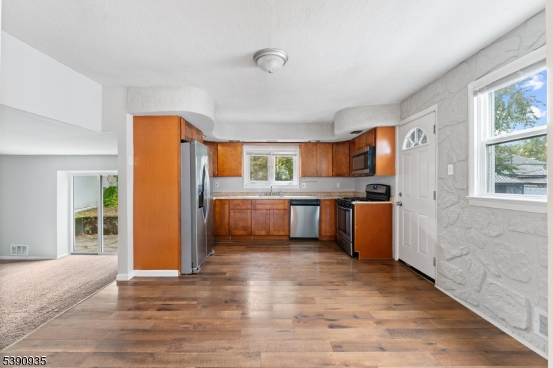 87 Pompton Avenue Little Falls, NJ 07424 - Photo 10 of 34 a kitchen with stainless steel appliances a refrigerator and a stove
