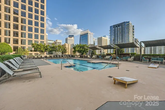 a swimming pool with outdoor seating and a patio