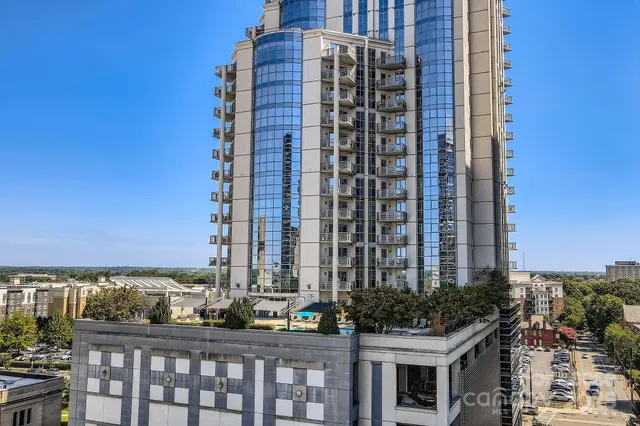 a view of a balcony with wooden floor and city view